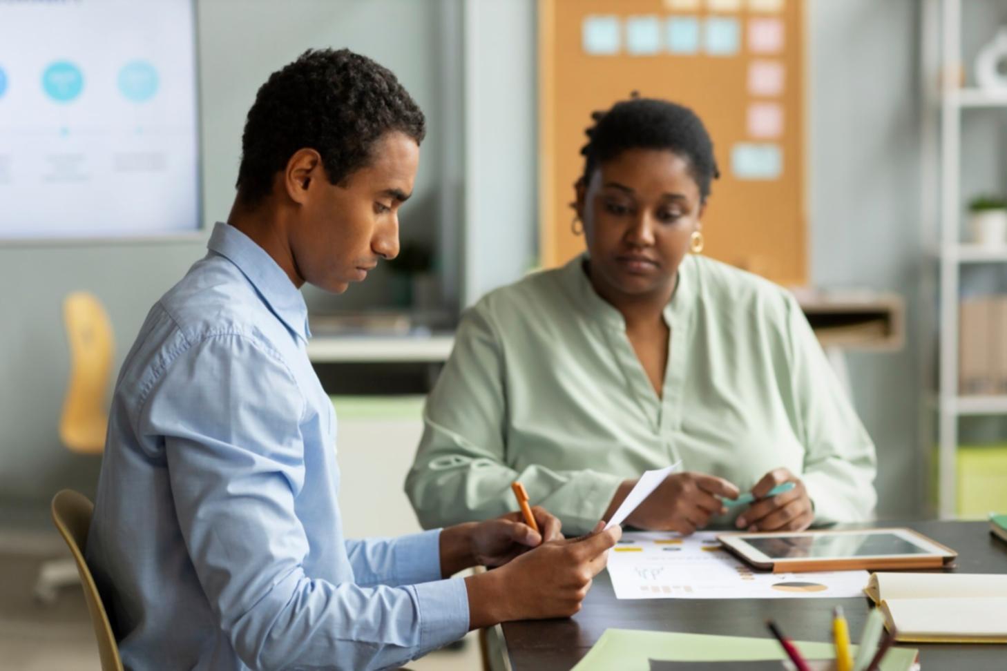 Financial planning workshop session with participants reviewing seasonal budget strategies